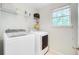Well-lit laundry room with modern washer and dryer, plus convenient shelving at 1200 Out Of Bounds Dr, Summerville, SC 29485