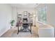 Home office with a large desk, floor-to-ceiling shelves, and a bright window at 1200 Out Of Bounds Dr, Summerville, SC 29485