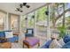 Cozy screened porch with comfortable furniture, ceiling fans, and view of the backyard at 1200 Out Of Bounds Dr, Summerville, SC 29485