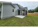 Backyard screened in porch and concrete patio with vinyl siding and lawn at 1207 Albert Storm Ave, Moncks Corner, SC 29461