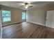 Spacious bedroom with modern ceiling fan, two large windows, and laminate flooring at 1207 Albert Storm Ave, Moncks Corner, SC 29461