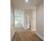 Neutral hallway with laminate flooring and white trim leads to various rooms of the house at 1207 Albert Storm Ave, Moncks Corner, SC 29461