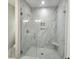 Elegant bathroom featuring marble-tiled shower with glass enclosure and recessed niche at 1207 Albert Storm Ave, Moncks Corner, SC 29461