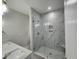 Luxurious marble tiled shower with a glass enclosure, built-in seat and dual vanity at 1207 Albert Storm Ave, Moncks Corner, SC 29461