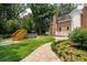 Expansive backyard featuring stone walkway, lush lawn, and a wooden hot tub deck at 125 Drayton Dr, Summerville, SC 29483