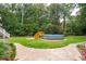 Spacious backyard with above-ground pool, deck, stone pathway and plenty of green space at 125 Drayton Dr, Summerville, SC 29483