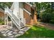 Exterior of home showing a staircase, stone walkway, manicured lawn, and brick exterior at 125 Drayton Dr, Summerville, SC 29483
