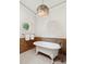 Elegant bathroom featuring a clawfoot tub, chandelier, and decorative window overlooking lush greenery at 125 Drayton Dr, Summerville, SC 29483