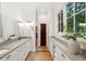 Bright bathroom with double vanity, granite countertop, ample storage, and natural light at 125 Drayton Dr, Summerville, SC 29483