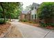 Long driveway leading to an attractive brick home with manicured landscaping and mature trees at 125 Drayton Dr, Summerville, SC 29483