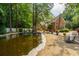 Beautiful brick home with a well-maintained koi pond and landscaping in a lush, wooded setting at 125 Drayton Dr, Summerville, SC 29483