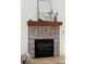 Close-up of the fireplace and decorative tile surround with a rustic wood mantle at 125 Drayton Dr, Summerville, SC 29483