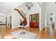 Spacious foyer with wood staircase and elegant chandelier at 125 Drayton Dr, Summerville, SC 29483