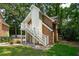 Garage apartment showcasing a private staircase in a lush, green setting, perfect for guests or rental at 125 Drayton Dr, Summerville, SC 29483