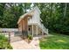 Exterior of a garage apartment with a private entrance and staircase, set in a landscaped yard at 125 Drayton Dr, Summerville, SC 29483