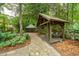 Scenic garden featuring two cozy gazebos, connected by a stone path, with comfortable seating amidst tranquil nature at 125 Drayton Dr, Summerville, SC 29483