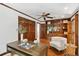 This home office features wood paneling, built-in shelving, and plenty of natural light at 125 Drayton Dr, Summerville, SC 29483