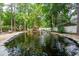 A serene koi pond features a rock waterfall, enhancing the backyard's tranquil setting at 125 Drayton Dr, Summerville, SC 29483
