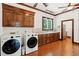 Well-equipped laundry room with wood cabinets, sink and modern washer and dryer at 125 Drayton Dr, Summerville, SC 29483
