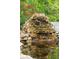 A tranquil water feature with rocks, waterfall, and a pond with goldfish at 125 Drayton Dr, Summerville, SC 29483
