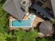 Aerial view of a stunning home with a pool, spa, and outdoor entertaining area, surrounded by lush greenery at 127 Blue Heron Pond Rd # C, Kiawah Island, SC 29455