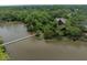 Beautiful aerial view of a luxury home surrounded by lush greenery and waterfront with a private pier at 127 Blue Heron Pond Rd # C, Kiawah Island, SC 29455