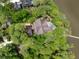 Panoramic aerial view of a luxury home with waterfront views, a pool, and lush landscaping at 127 Blue Heron Pond Rd # C, Kiawah Island, SC 29455