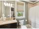 Bathroom featuring beige tile and shower with an exterior window for natural light at 127 Blue Heron Pond Rd # C, Kiawah Island, SC 29455