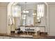 Elegant bathroom vanity with marble countertop, unique lighting, and a decorative mirror at 127 Blue Heron Pond Rd # C, Kiawah Island, SC 29455