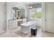 Luxurious bathroom featuring a modern soaking tub, designer vanity, and elegant finishes at 127 Blue Heron Pond Rd # C, Kiawah Island, SC 29455