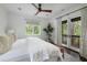 Inviting bedroom features a large bed, stylish furnishings, and French doors leading to a private balcony at 127 Blue Heron Pond Rd # C, Kiawah Island, SC 29455