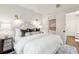 Bedroom featuring neutral color palette, bedside tables, and an open doorway at 127 Blue Heron Pond Rd # C, Kiawah Island, SC 29455
