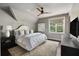 Comfortable bedroom offers a ceiling fan, picture window, and neutral color palette at 127 Blue Heron Pond Rd # C, Kiawah Island, SC 29455