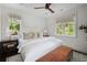 Bright bedroom with neutral color scheme, decorative pillows, bench and dual windows offering abundant natural light at 127 Blue Heron Pond Rd # C, Kiawah Island, SC 29455