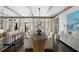 Bright dining room with long table, decorative lighting, and an open concept design into the living area at 127 Blue Heron Pond Rd # C, Kiawah Island, SC 29455