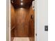 Interior view of a wood-paneled elevator with a handrail and classic control panel at 127 Blue Heron Pond Rd # C, Kiawah Island, SC 29455