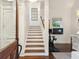 Welcoming entryway with staircase, dark hardwood floors, and exercise equipment in the background at 127 Blue Heron Pond Rd # C, Kiawah Island, SC 29455