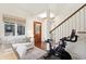 Welcoming entryway with hardwood floors, staircase, and seating area at 127 Blue Heron Pond Rd # C, Kiawah Island, SC 29455