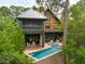 Stunning backyard with an inground pool, hot tub, screened in porch, and lots of greenery at 127 Blue Heron Pond Rd # C, Kiawah Island, SC 29455