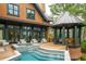 Home exterior featuring a hot tub, outdoor seating area, and lush landscaping at 127 Blue Heron Pond Rd # C, Kiawah Island, SC 29455