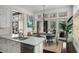 Bright kitchen with white cabinets, a large island, and stainless steel appliances at 127 Blue Heron Pond Rd # C, Kiawah Island, SC 29455