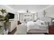 Bright main bedroom featuring a tufted headboard, walkout balcony, and stylish furnishings at 127 Blue Heron Pond Rd # C, Kiawah Island, SC 29455