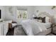 Relaxing main bedroom featuring a plush bed, stylish decor, and natural light, creating a serene retreat at 127 Blue Heron Pond Rd # C, Kiawah Island, SC 29455