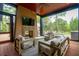 Enjoy the outdoor living space on this screened porch with a fireplace, tv and view of the pool at 127 Blue Heron Pond Rd # C, Kiawah Island, SC 29455
