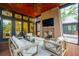 Screened patio boasts comfortable seating, a fireplace, and a view of the pool for relaxation and entertainment at 127 Blue Heron Pond Rd # C, Kiawah Island, SC 29455