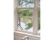 Window view of serene pond and trees provides a tranquil connection to nature at 127 Blue Heron Pond Rd # C, Kiawah Island, SC 29455