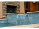 Close-up of attractive water feature with stacked stone and falling water in the exterior of this home at 127 Blue Heron Pond Rd # C, Kiawah Island, SC 29455