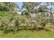 An aerial view of a backyard with blueberry bushes, trees, and green grass at 127 Roberts Rd, Summerville, SC 29483