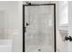 Glass shower enclosure with marble tiled surround and matte black fixtures at 127 Roberts Rd, Summerville, SC 29483