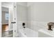 Clean white tub with marble tiled accent wall and matte black fixtures at 127 Roberts Rd, Summerville, SC 29483